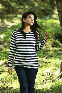woman standing holding on strands of hair thumbnail