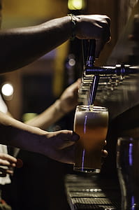 person dispensing beer on glass thumbnail