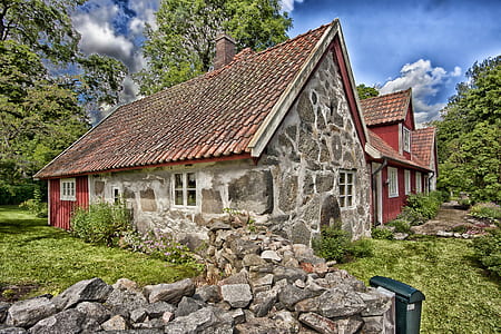 rock house with grass and trees thumbnail