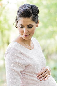 close-up photography of pregnant woman wearing beige dress thumbnail