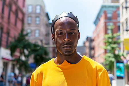 selective focus photography of man in yellow shirt thumbnail