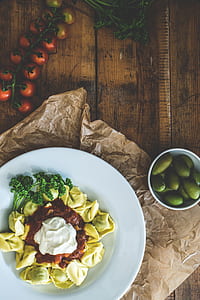 flat lay photography of pasta on plate near bowl thumbnail
