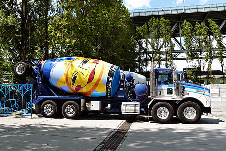 blue and white cement mixer on road at daytime thumbnail