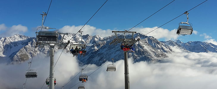 white cable cars far away from snow mountains thumbnail