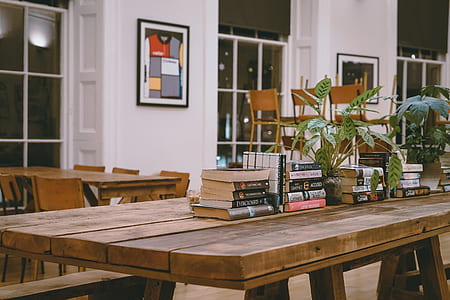 assorted books on top of brown wooden table thumbnail