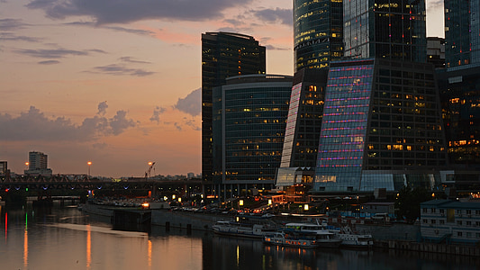 high rise buildings near body of water during golden hour thumbnail