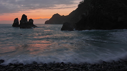 rock formations on body of water thumbnail