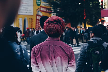 man in purple and white sport shirt standing near pedestrian lane thumbnail