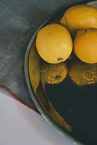 three orange lemon on round stainless steel tray thumbnail