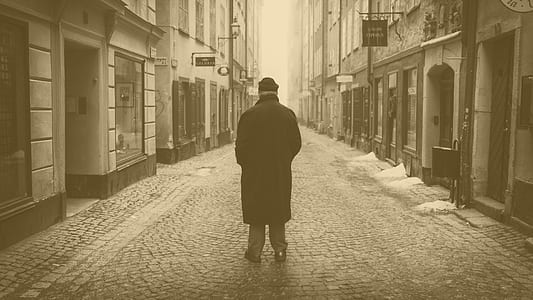 man wearing black coat and hat thumbnail