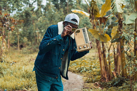 Man Holding Brown Boombox Radio thumbnail