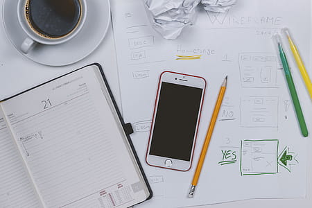 Web developer make some prototyping. Coffee, diary and smartphone on the table thumbnail