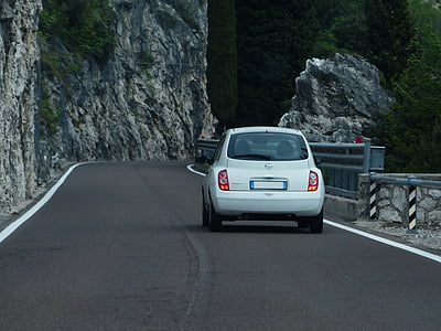 white Nissan hatchback on bridge thumbnail