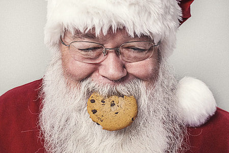 Santa Claus with cookie on his mouth thumbnail