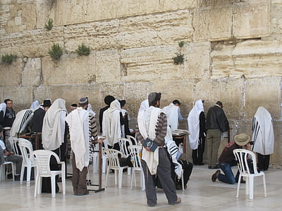 people gathered beside beige wall thumbnail