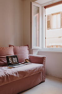 Workplace with a laptop on a pink couch thumbnail