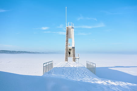 beige metal tower near sand thumbnail