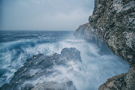 body of water near cliff thumbnail