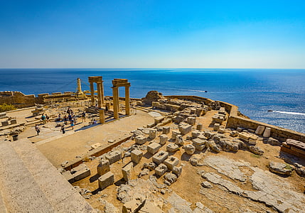 photography of people on ruins near body of water thumbnail