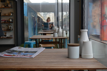 white paper cups and newspaper on brown table thumbnail