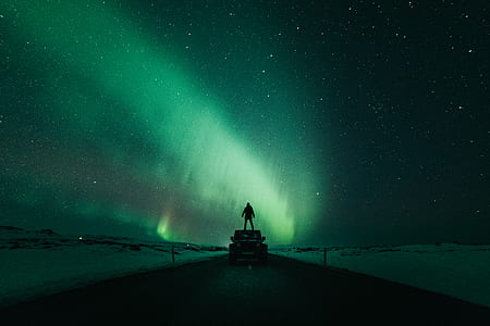 silhouette of person standing on vehicle under sky phenomenon thumbnail