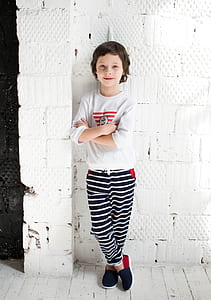 girl in white and red crew-neck long-sleeved shirt during daytime thumbnail