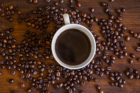 coffee mug surrounded by scattered coffee beans thumbnail