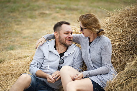 Man and Woman Sitting on Hay thumbnail