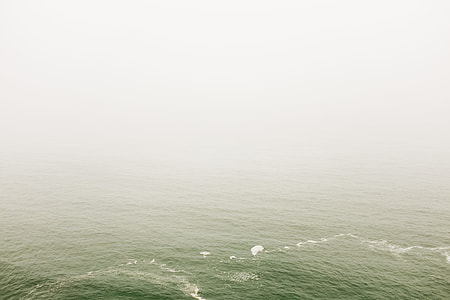 body of water under gray sky thumbnail