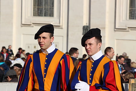 two men in blue and orange striped uniform standing thumbnail