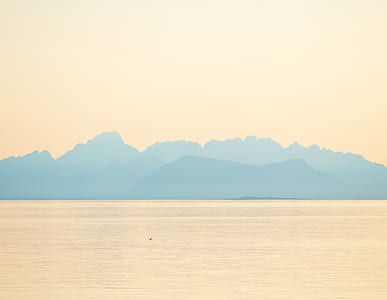 mountain range near body of water thumbnail