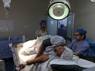 woman lying on hospital bed while having operation thumbnail