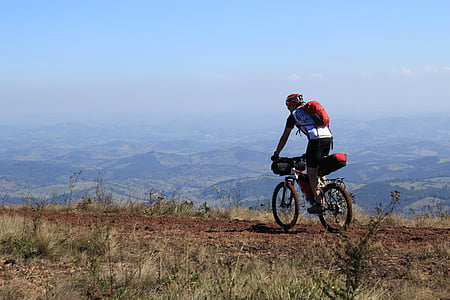 man riding on mountain bike under blue sky at daytime thumbnail