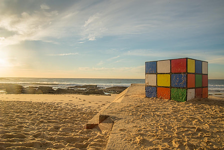 selective focus photography of 3x3 Rubik's cube on beach sand thumbnail