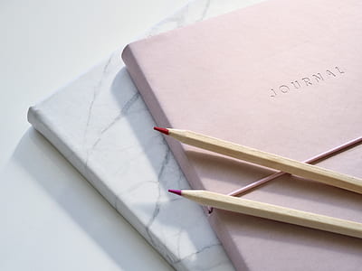 closeup photo of beige pencil on book thumbnail