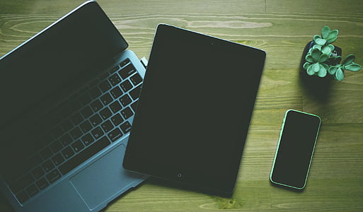 space gray iPad beside gray laptop computer thumbnail