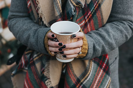 person holding brown and white disposable cup thumbnail