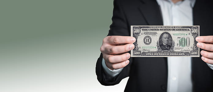 person showing 500 US dollar banknote in selective focus photography thumbnail