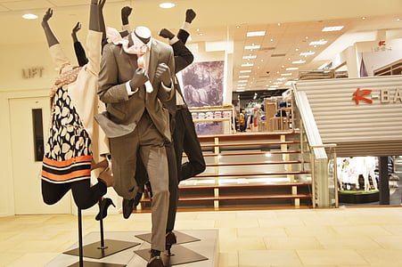 mannequins with suits and dresses displayed inside white room thumbnail