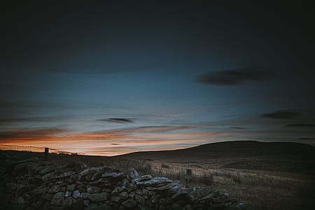 brown mountain under blue sky at sunset thumbnail