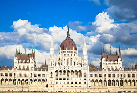 white and brown dome building under cloudy sky thumbnail