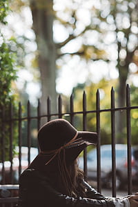 woman looking sideways near bars udring daytime thumbnail