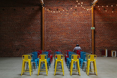 person sitting on chair near wall thumbnail