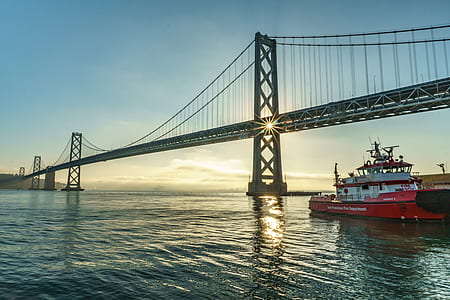 red and white boat under concrete bridge thumbnail