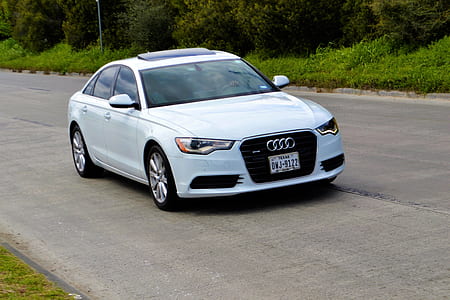white Audi sedan on gray road thumbnail