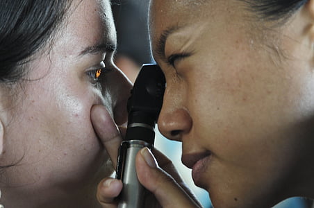person lighting woman's eye thumbnail