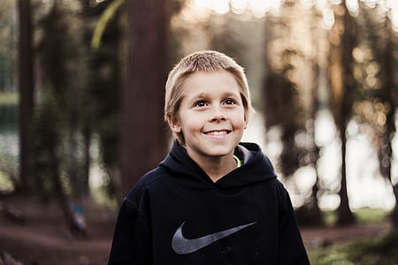 selective focus photography of boy wearing black Nike hoodie thumbnail