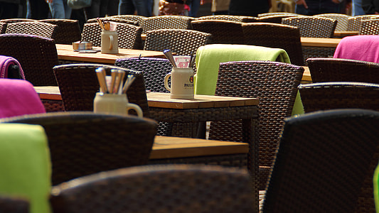 dining tables and chairs with ceramic mugs and stainless steel flatware on top thumbnail