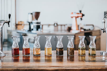 selective focus photography assorted clear glass bottles on table thumbnail