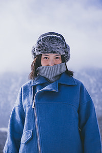 woman in blue coat and black and gray hat thumbnail